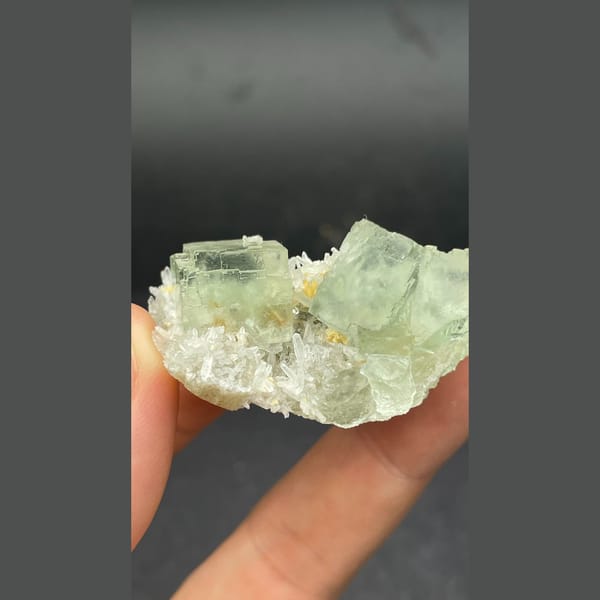 Icy pale green fluorite cubes with white quartz from Fujian — detail view