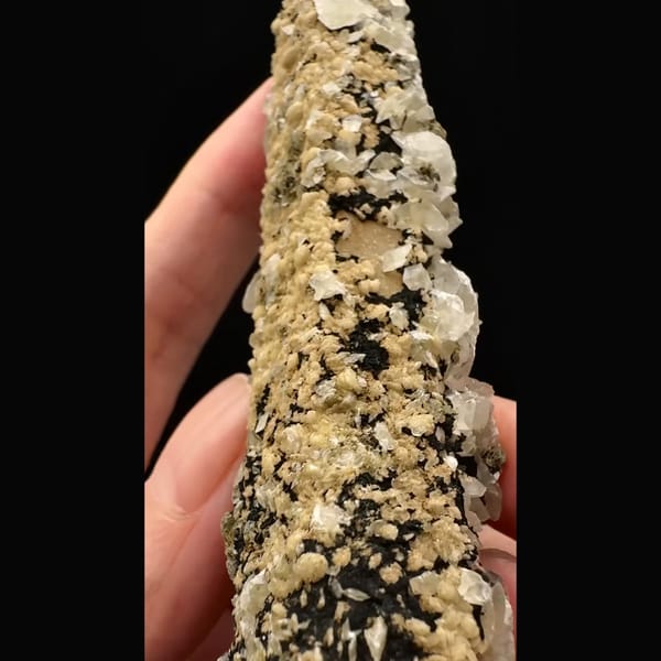 Tall quartz crystal crusted with bladed calcite and golden dolomite from Inner Mongolia — detail view