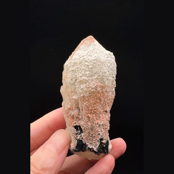 Pinkish-white coated quartz crystal with black specular hematite from Inner Mongolia — complete view