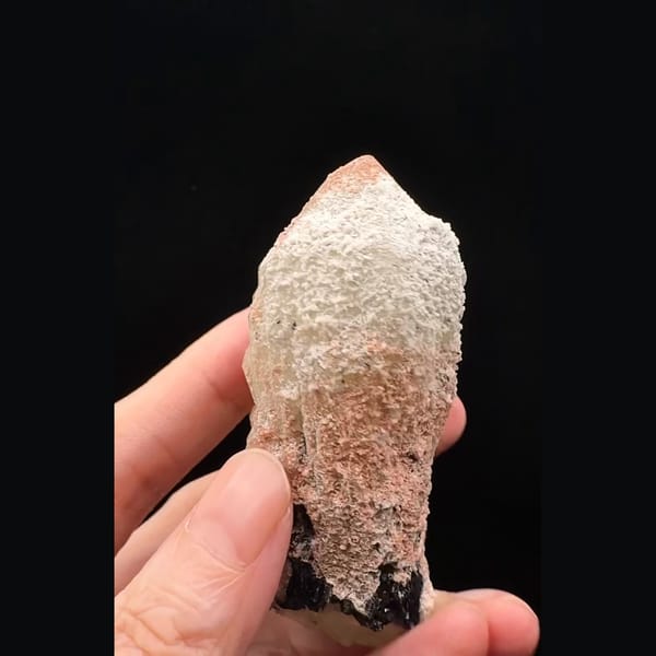 Pinkish-white coated quartz crystal with black specular hematite from Inner Mongolia — alternate view