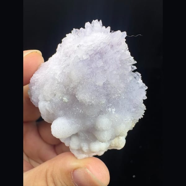 Round purple creedite and white gypsum cluster from Qinglong — detail view