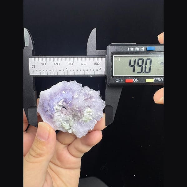 Round purple creedite and white gypsum cluster from Qinglong — detail view