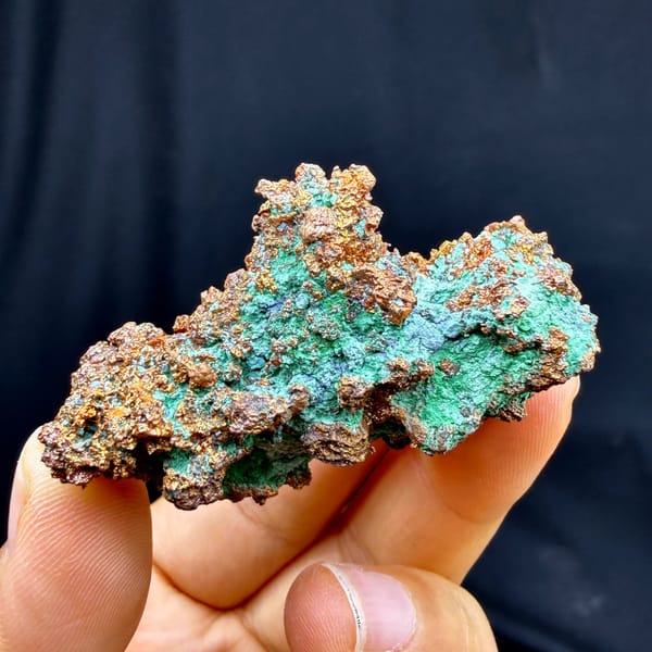 Bright green malachite crust on native copper — detail view