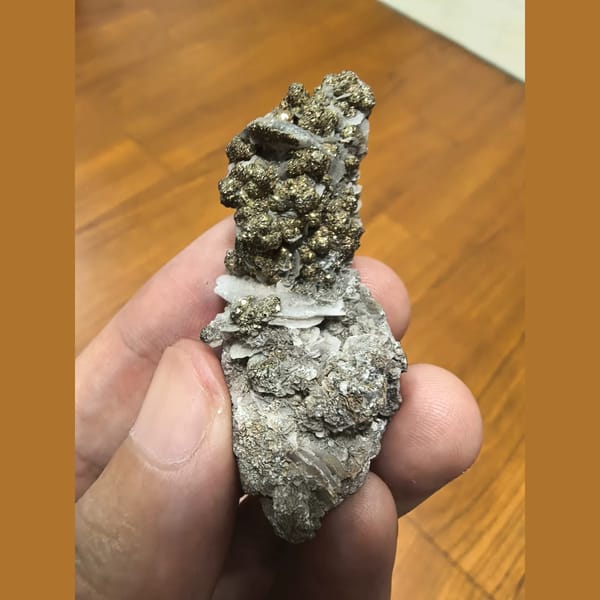 Shiny pyrite balls with calcite — complete view