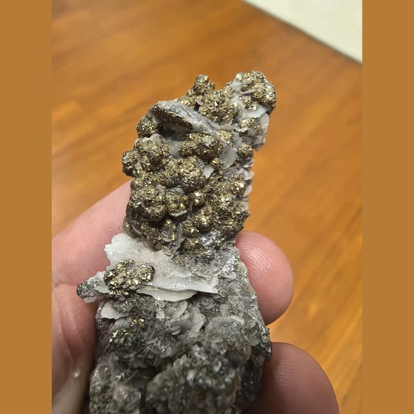 Shiny pyrite balls with calcite — alternate view