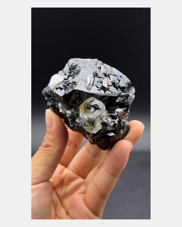 Complete front view of cassiterite with aquamarine crystals