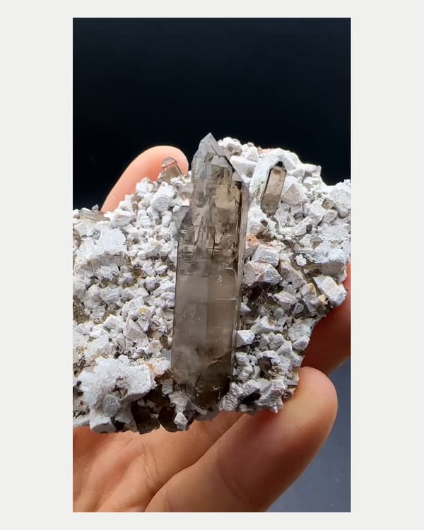 Complete front view of smoky quartz with hyalite and feldspar