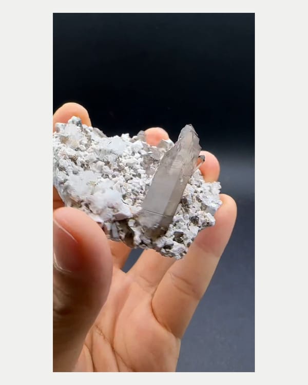 Complete right oblique view of smoky quartz with hyalite and feldspar