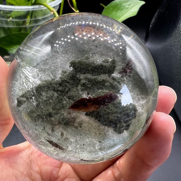 Clear quartz sphere with green phantoms and a moving water bubble from Brazil — complete view