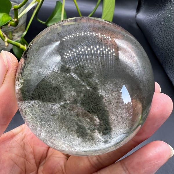 Clear quartz sphere with green phantoms and a moving water bubble from Brazil — alternate view