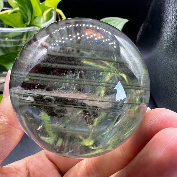 Clear quartz sphere with green phantoms and a moving water bubble from Brazil — alternate view