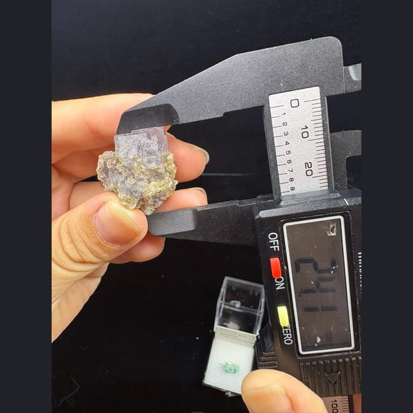 Small glassy purple fluorite with mica from Yaogangxian — alternate view