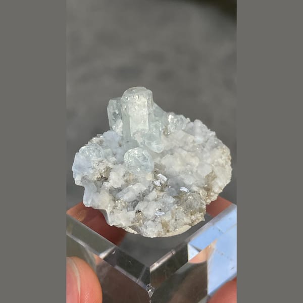 Columnar pale blue aquamarine on dolomite with mica from Xuebaoding, Sichuan — alternate view