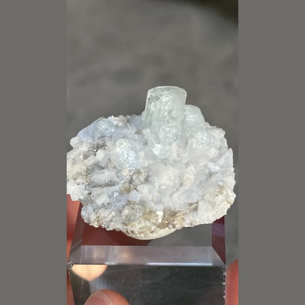 Columnar pale blue aquamarine on dolomite with mica from Xuebaoding, Sichuan — detail view