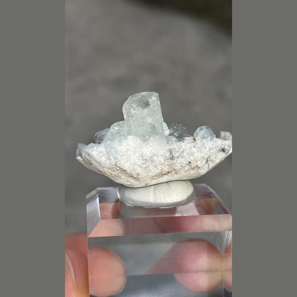 Columnar pale blue aquamarine on dolomite with mica from Xuebaoding, Sichuan — detail view