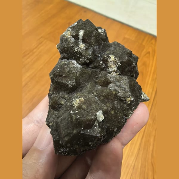 Brown garnet cluster with goethite and quartz — complete view