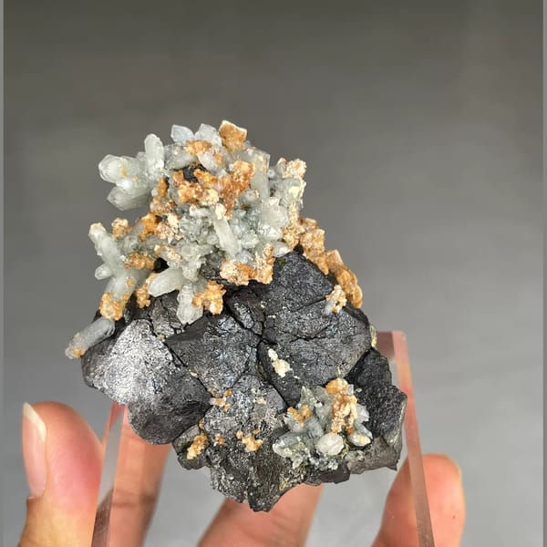 Pale green quartz crystals on black magnetite from Inner Mongolia — alternate view