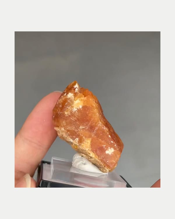 Complete side view of amber-orange scheelite and pale lower material