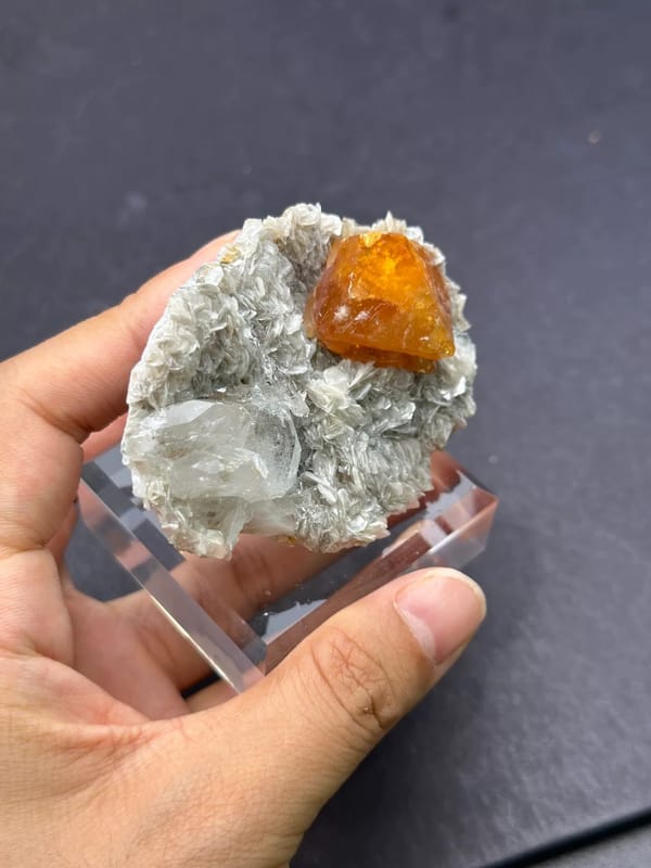 Complete higher oblique view showing the aquamarine, orange scheelite and layered mica
