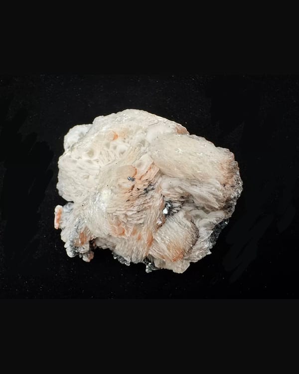 Whole front of pink-white layered calcite with reflective specular hematite, Inner Mongolia