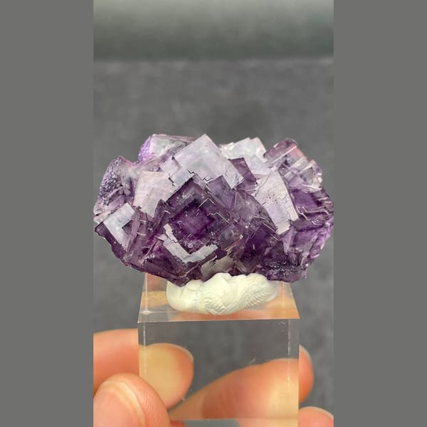 Purple fluorite cluster with geometric phantoms from Henan — complete view