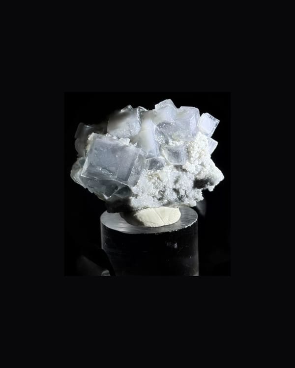 Complete front view of pale gray Xianghualing fluorite with quartz