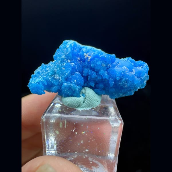 Bright blue frothy allophane from Qinglong, Guizhou on a stand — complete view
