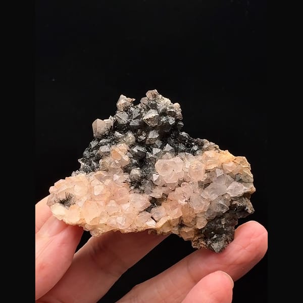 Pale pink quartz with dark goethite-coated quartz from Morocco — complete view