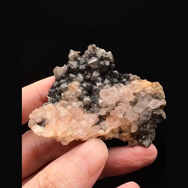 Pale pink quartz with dark goethite-coated quartz from Morocco — alternate view
