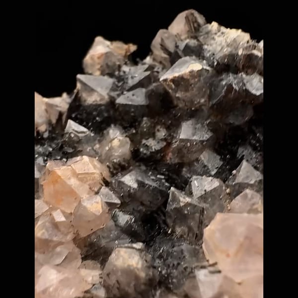 Pale pink quartz with dark goethite-coated quartz from Morocco — detail view