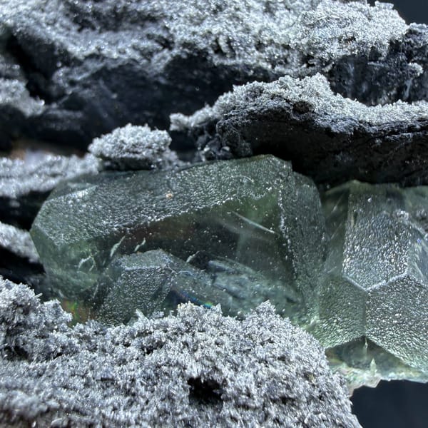 Green fluorite in hollows of a layered quartz-coated matrix from Fujian — alternate view