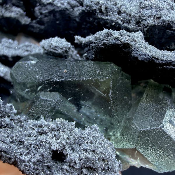 Green fluorite in hollows of a layered quartz-coated matrix from Fujian — alternate view