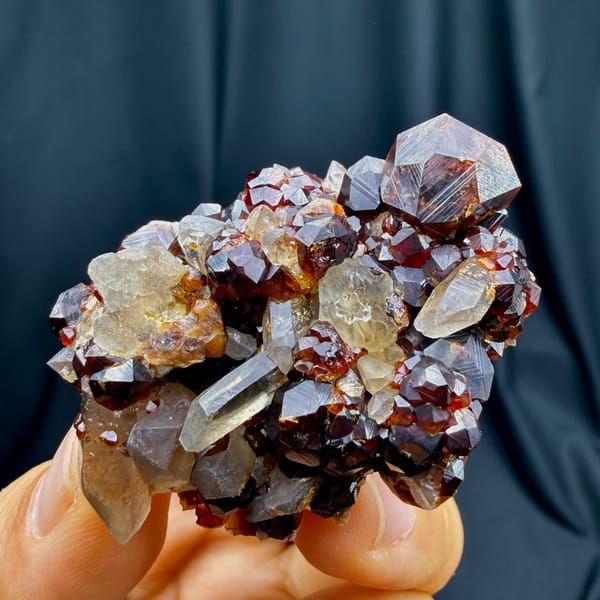 Glossy red-brown spessartine garnet crystals with smoky quartz from Yunxiao, Fujian — alternate view
