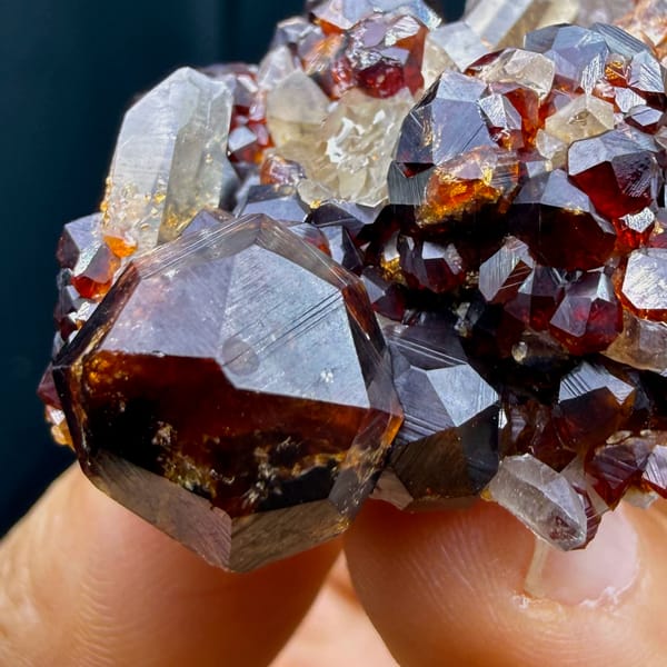Glossy red-brown spessartine garnet crystals with smoky quartz from Yunxiao, Fujian — detail view