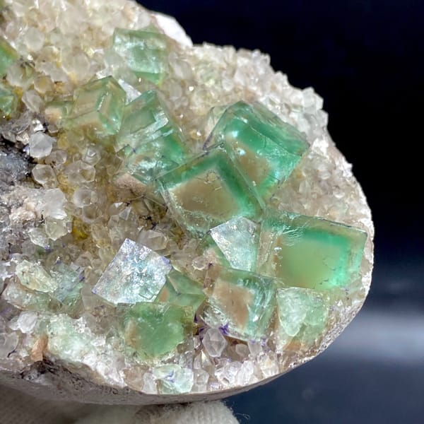 Green fluorite cubes on a sparkling quartz plate from Hebei — detail view
