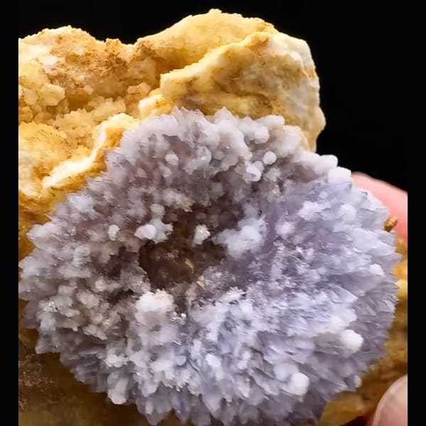 Lavender-purple creedite half-ball on golden-brown matrix from Guizhou — detail view