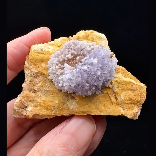 Lavender-purple creedite half-ball on golden-brown matrix from Guizhou — detail view