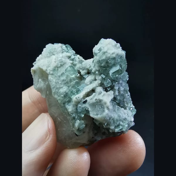 Clear blue fluorite on grey quartz — complete view