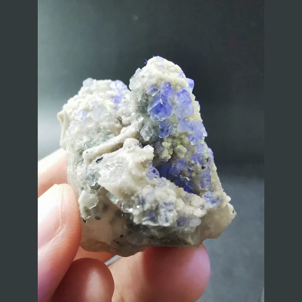 Clear blue fluorite on grey quartz — detail view