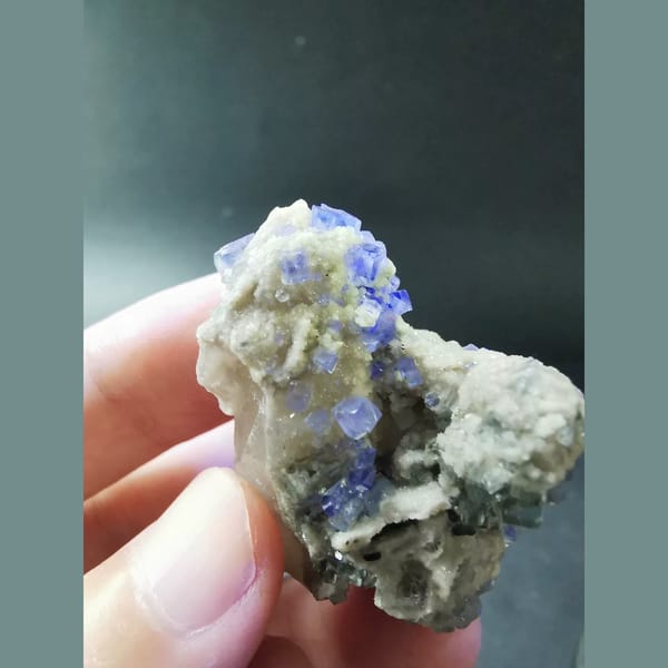 Clear blue fluorite on grey quartz — detail view