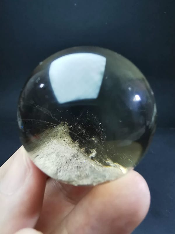 Complete opposite view of the same quartz sphere with the inclusion forming a central ridge