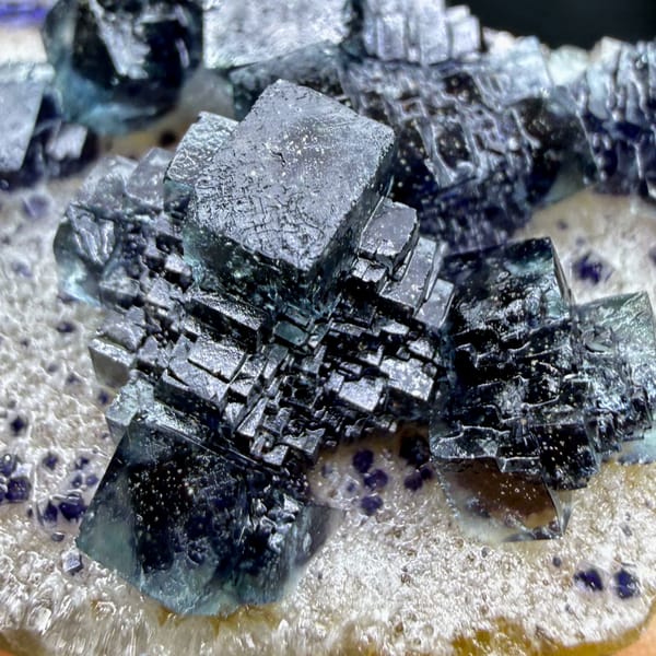 Dark blue-green stepped cubic fluorite on white quartz from Inner Mongolia — alternate view