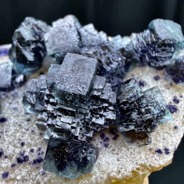 Dark blue-green stepped cubic fluorite on white quartz from Inner Mongolia — detail view