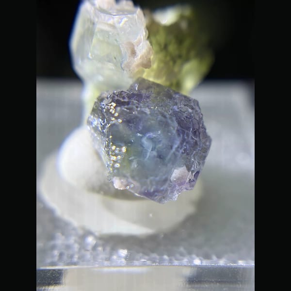 Etched blue fluorite with quartz and rhodochrosite from Piaotang — detail view
