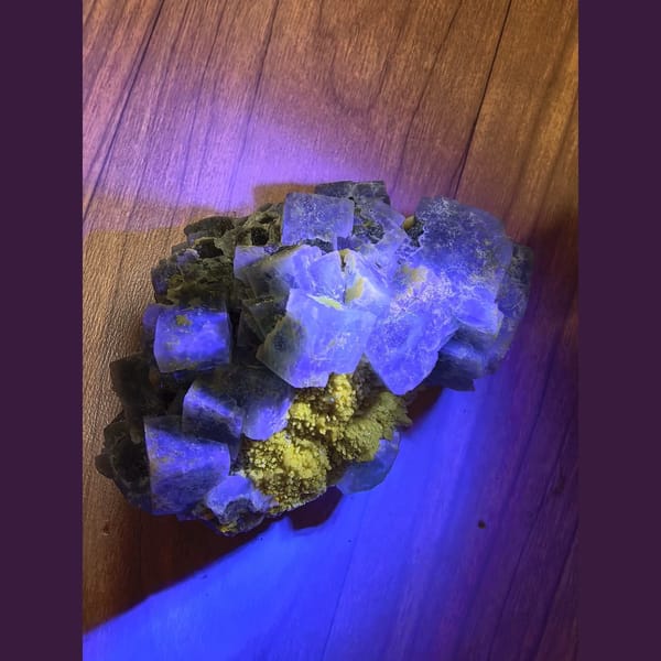 Large green cubic fluorite on candle quartz — detail view