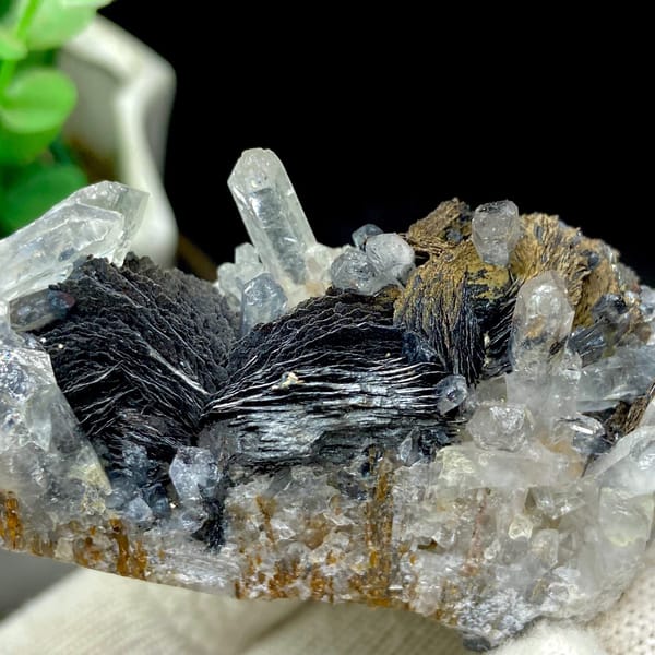 Clear quartz points with black bladed specular hematite from Guangdong — detail view