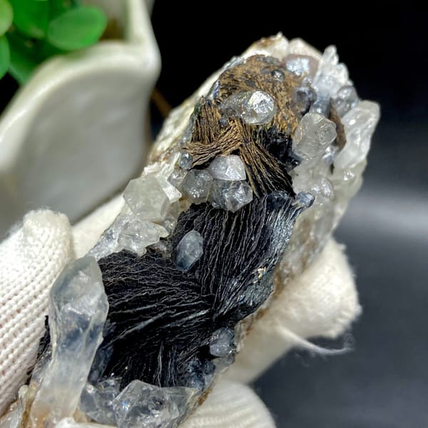 Clear quartz points with black bladed specular hematite from Guangdong — detail view