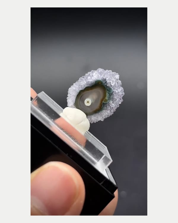 Complete thin edge view of miniature Uruguayan quartz slice