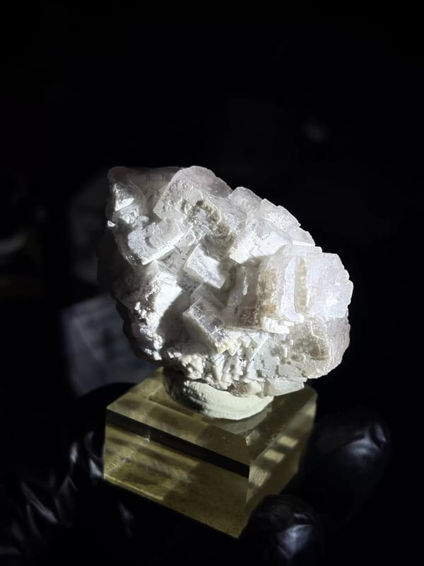 Complete side face showing pale violet fluorite beneath the coating