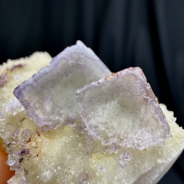 Pale lilac cubic fluorite on white creedite and quartz from Guizhou — detail view